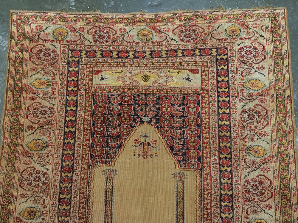 An antique late 19th-century Turkish Kayseri silk prayer rug featuring a central beige mihrab niche surrounded by geometric red and navy borders. View III