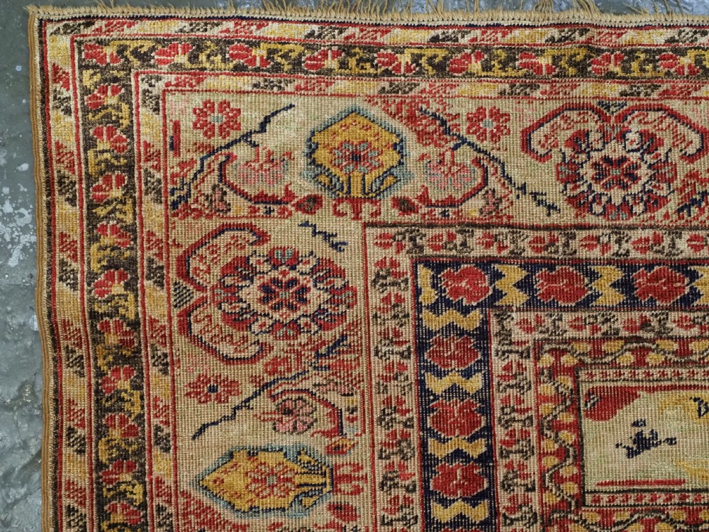 An antique late 19th-century Turkish Kayseri silk prayer rug featuring a central beige mihrab niche surrounded by geometric red and navy borders. View VI