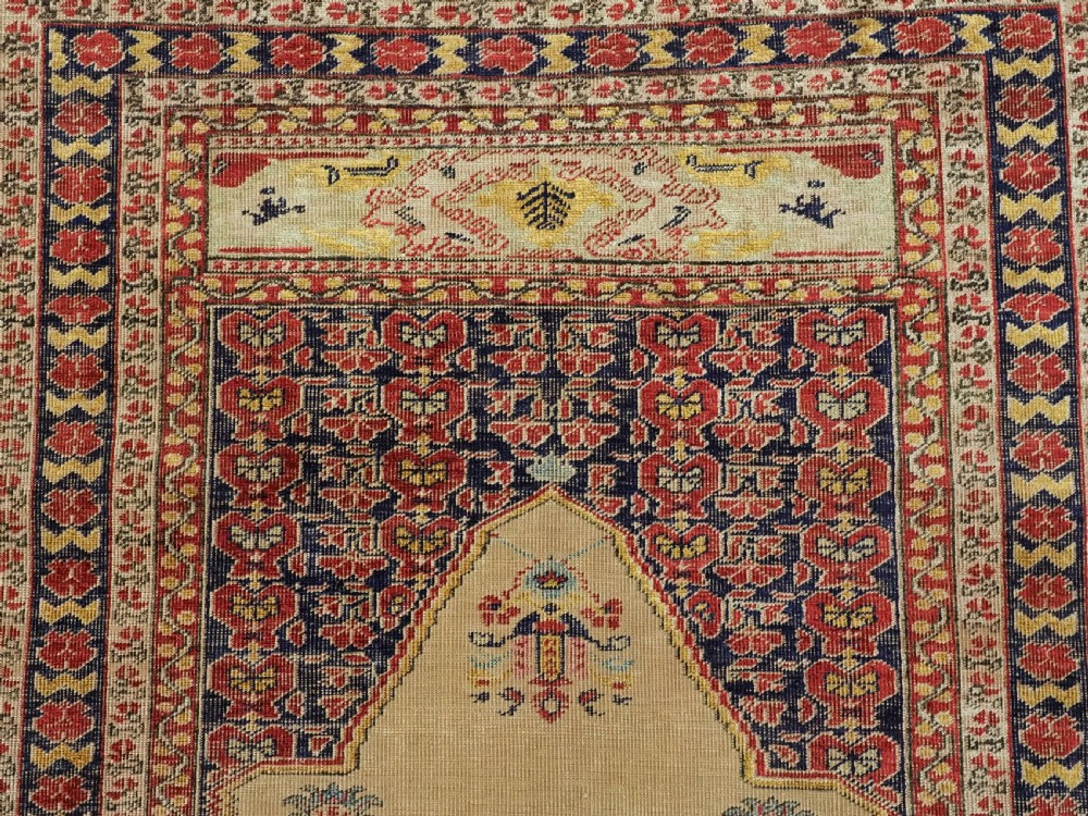 An antique late 19th-century Turkish Kayseri silk prayer rug featuring a central beige mihrab niche surrounded by geometric red and navy borders. View VIII