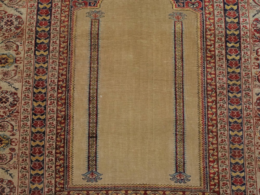 An antique late 19th-century Turkish Kayseri silk prayer rug featuring a central beige mihrab niche surrounded by geometric red and navy borders. View IX