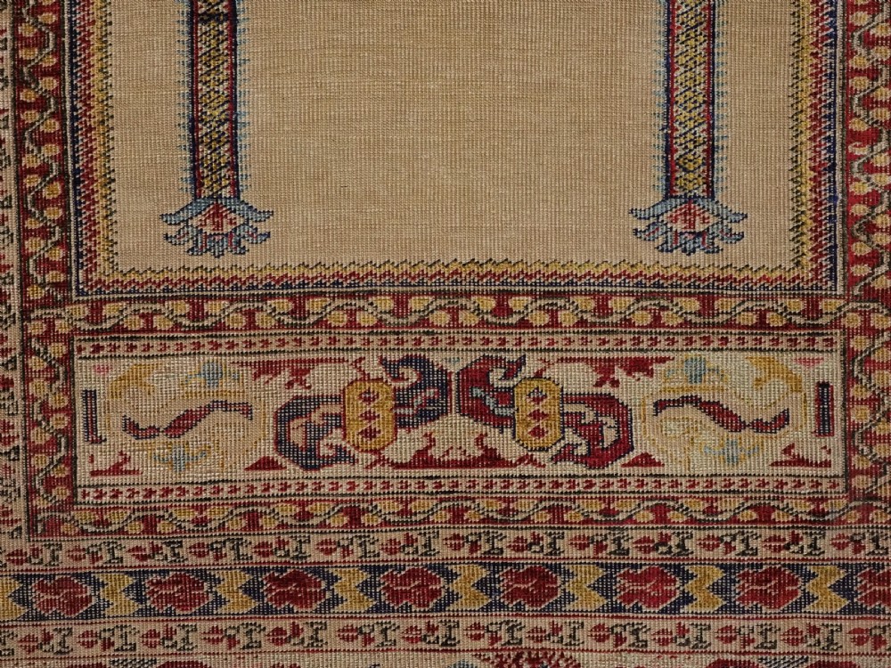 An antique late 19th-century Turkish Kayseri silk prayer rug featuring a central beige mihrab niche surrounded by geometric red and navy borders. View XIII