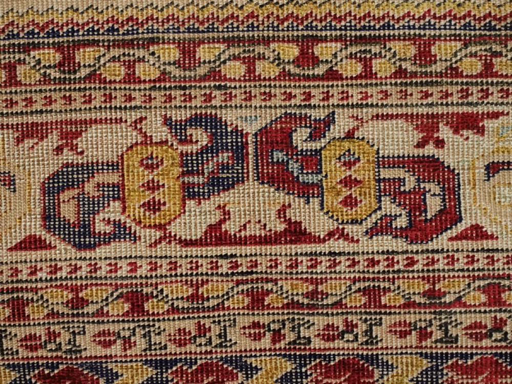 An antique late 19th-century Turkish Kayseri silk prayer rug featuring a central beige mihrab niche surrounded by geometric red and navy borders. View XIV