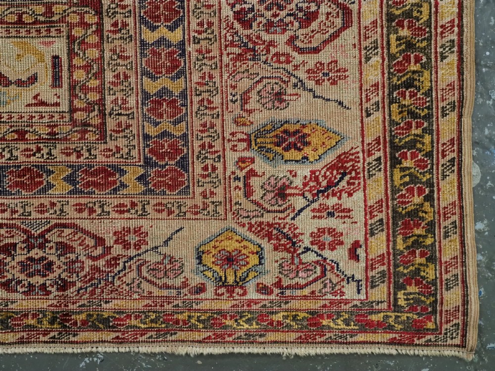 An antique late 19th-century Turkish Kayseri silk prayer rug featuring a central beige mihrab niche surrounded by geometric red and navy borders. View XVI