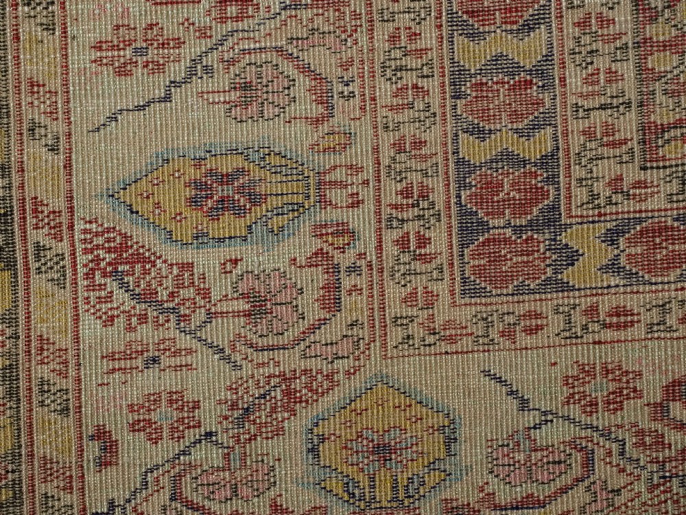An antique late 19th-century Turkish Kayseri silk prayer rug featuring a central beige mihrab niche surrounded by geometric red and navy borders. View XVII
