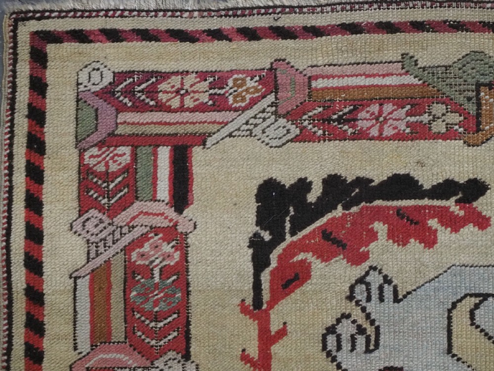 An antique Turkish Kirsehir wool prayer rug featuring a cream central field with a pointed mihrab niche, central tree of life motif, and geometric floral borders in muted red, pink, and green tones. View VI