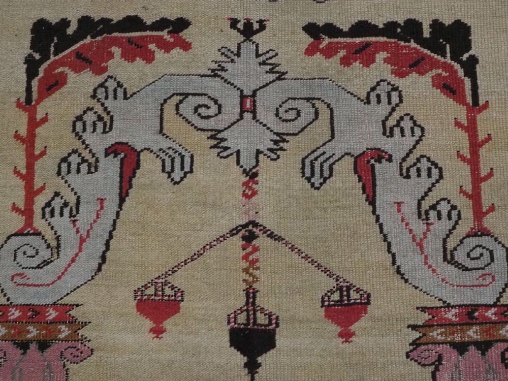 An antique Turkish Kirsehir wool prayer rug featuring a cream central field with a pointed mihrab niche, central tree of life motif, and geometric floral borders in muted red, pink, and green tones. View VIII