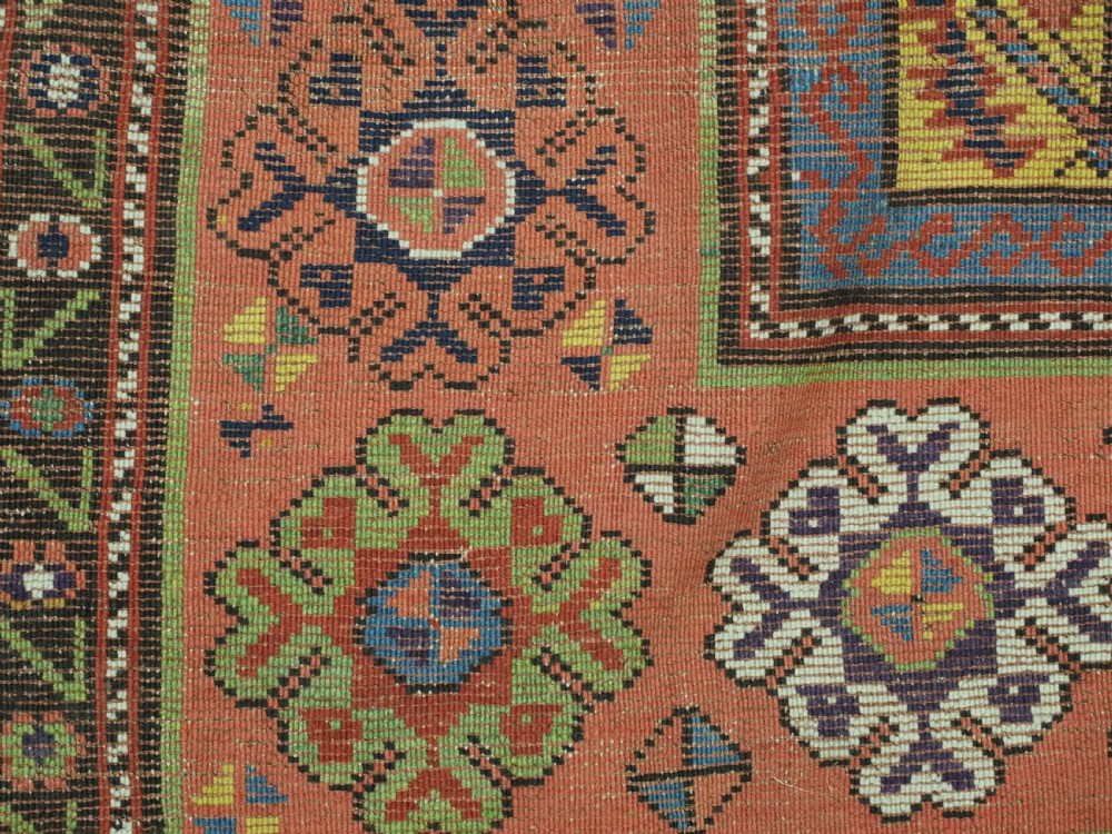 An antique long hand-knotted wool runner rug featuring a yellow lattice pattern field framed by wide red floral geometric borders. View XI