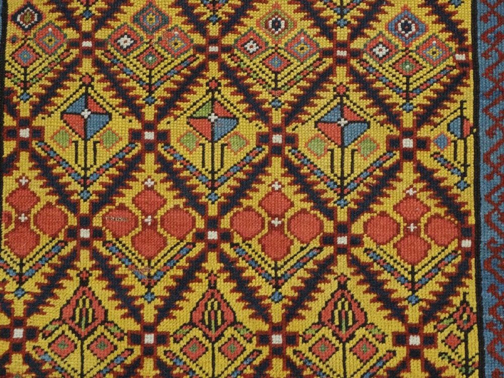 An antique long hand-knotted wool runner rug featuring a yellow lattice pattern field framed by wide red floral geometric borders. View XIII