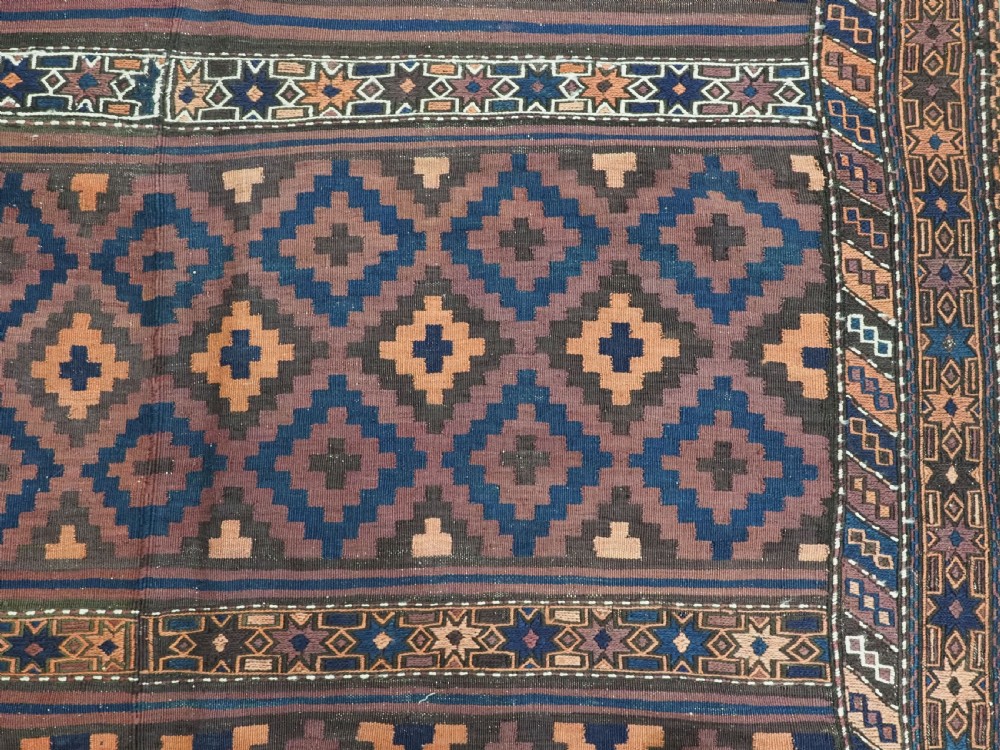 A large flatweave Baluch wool kilim rug featuring two joined panels with geometric diamond bands in terracotta, indigo, and dark brown hues. View XIII