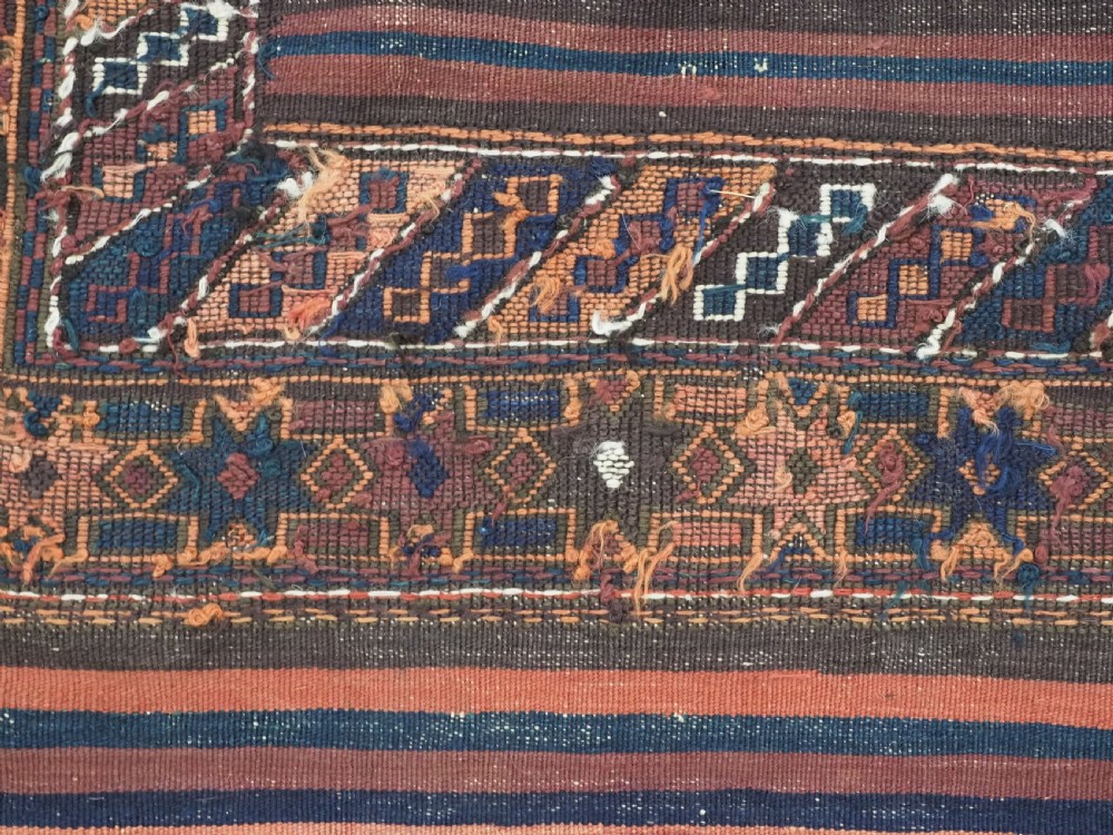 A large flatweave Baluch wool kilim rug featuring two joined panels with geometric diamond bands in terracotta, indigo, and dark brown hues. View XVI