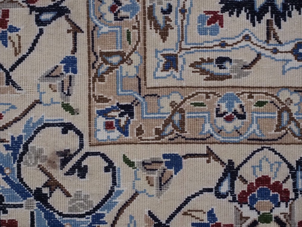 An antique hand-knotted Persian Nain carpet featuring an intricate central medallion in light blue and cream set against a deep navy blue field surrounded by elaborate floral borders. View XIII