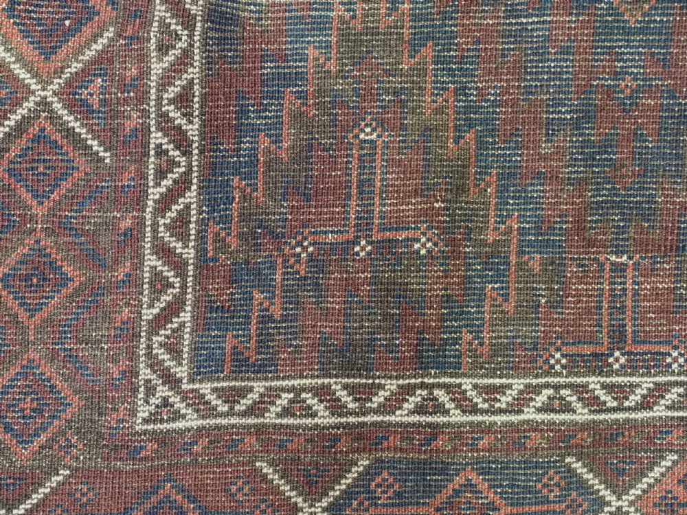 An antique hand-woven Arab Baluch runner rug featuring a dark navy blue and deep red geometric diamond lattice pattern with outer geometric borders. View XIII