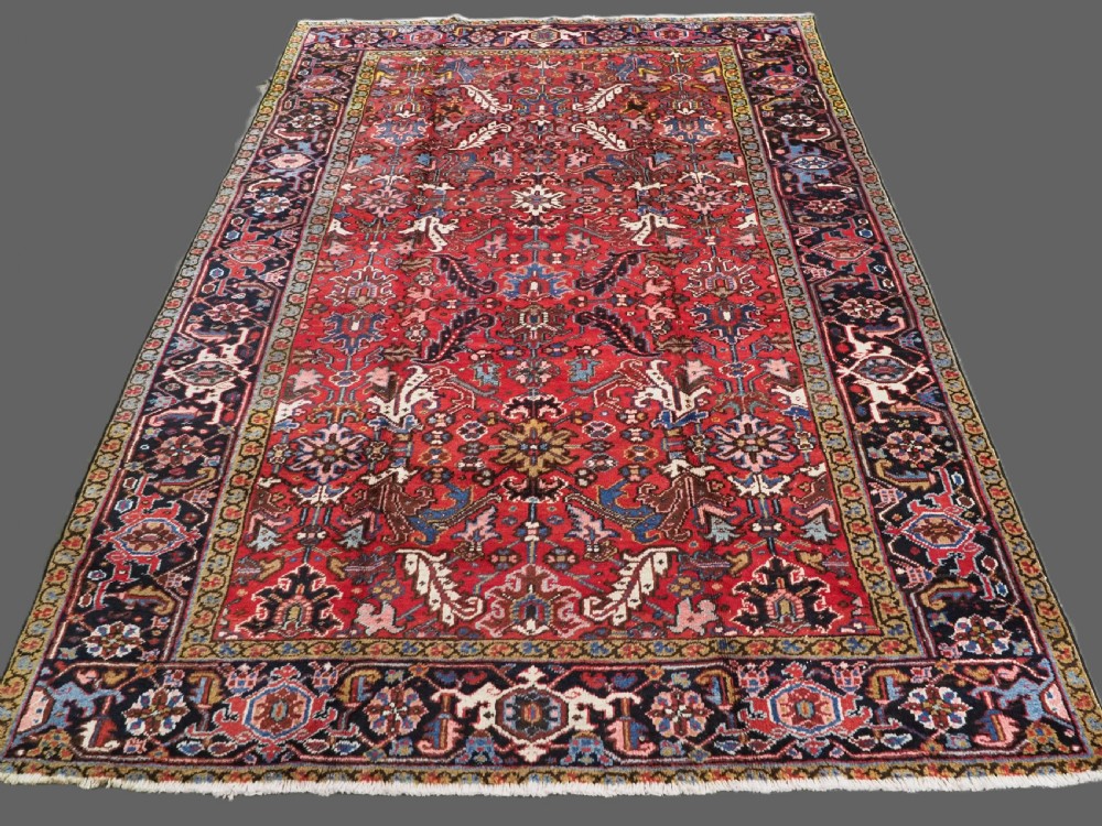 ANTIQUE HERIZ CARPET, ALL OVER DESIGN ON A BOLD RED GROUND, CIRCA 1920/30.