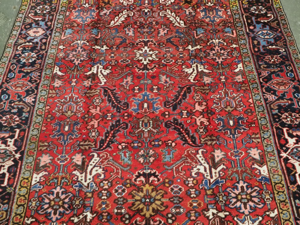ANTIQUE HERIZ CARPET, ALL OVER DESIGN ON A BOLD RED GROUND, CIRCA 1920/30. View IV