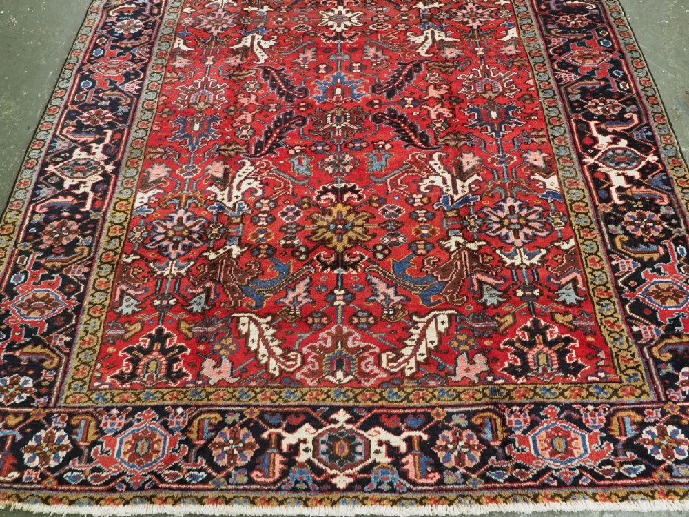 ANTIQUE HERIZ CARPET, ALL OVER DESIGN ON A BOLD RED GROUND, CIRCA 1920/30. View V