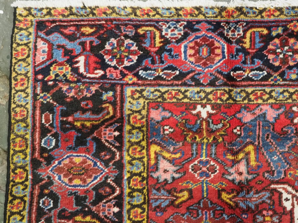 ANTIQUE HERIZ CARPET, ALL OVER DESIGN ON A BOLD RED GROUND, CIRCA 1920/30. View VI