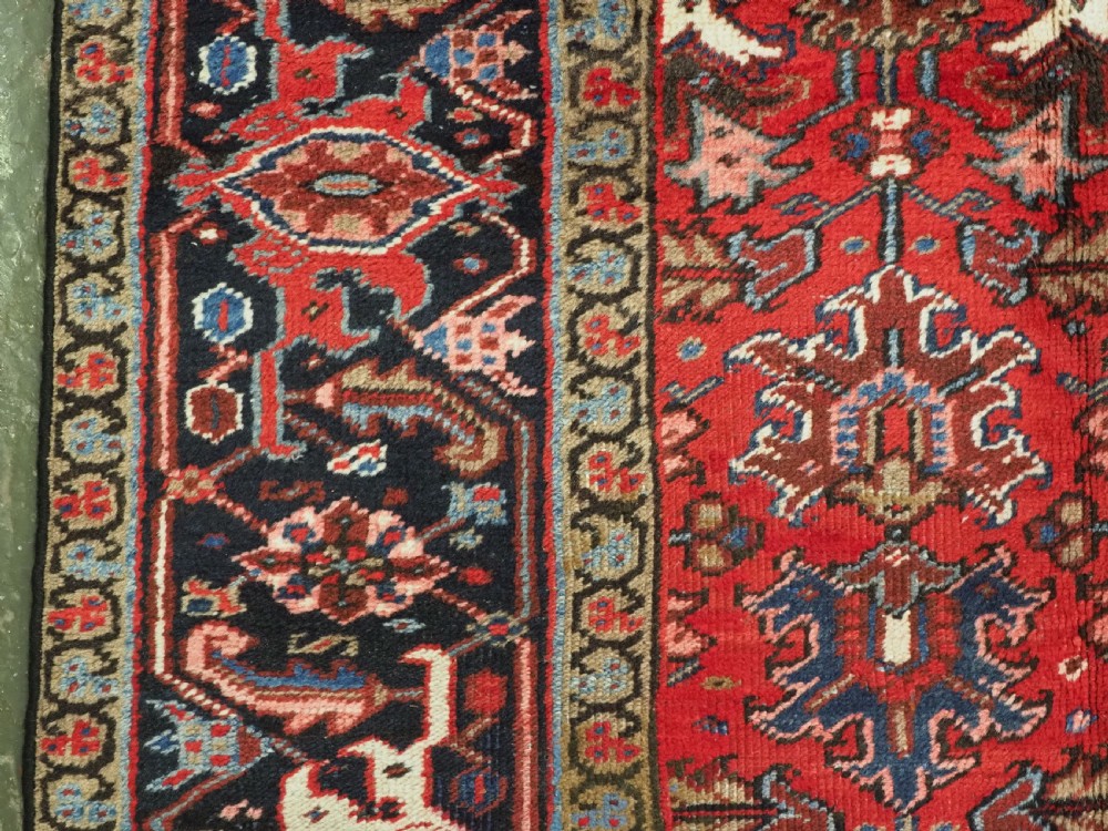ANTIQUE HERIZ CARPET, ALL OVER DESIGN ON A BOLD RED GROUND, CIRCA 1920/30. View VII