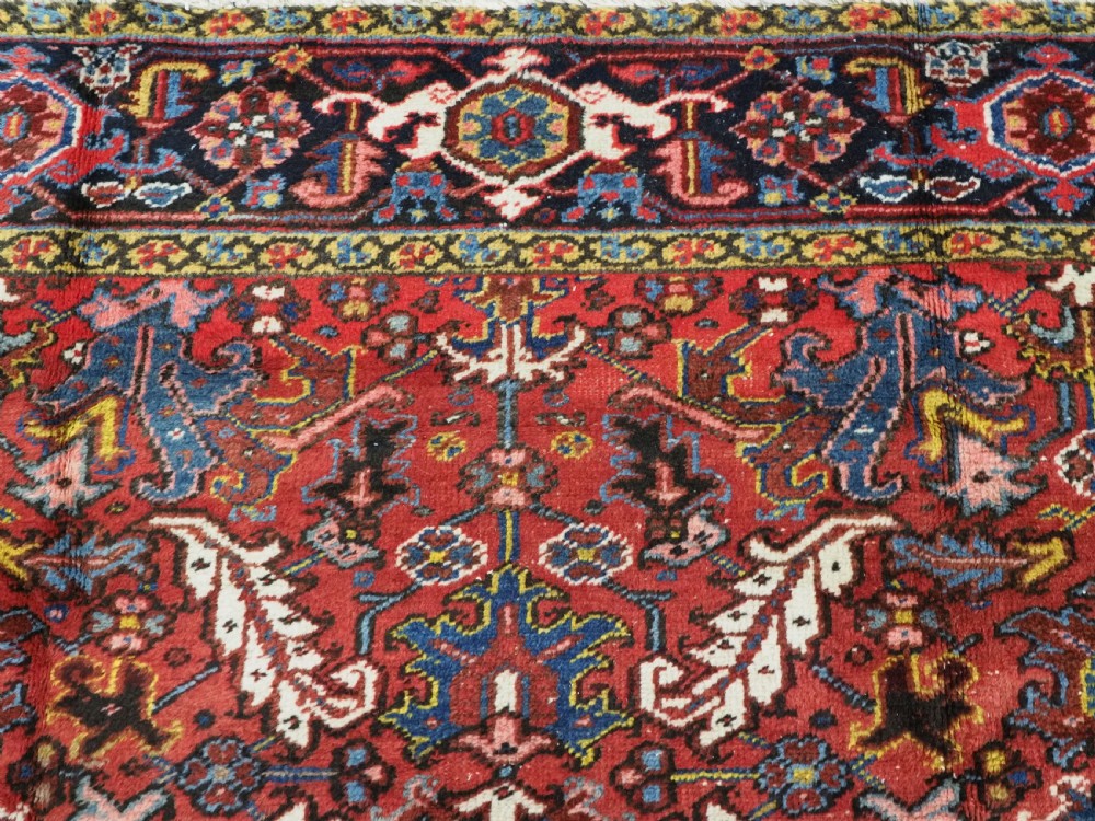 ANTIQUE HERIZ CARPET, ALL OVER DESIGN ON A BOLD RED GROUND, CIRCA 1920/30. View VIII
