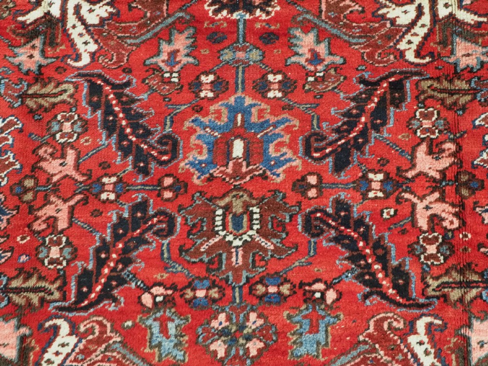 ANTIQUE HERIZ CARPET, ALL OVER DESIGN ON A BOLD RED GROUND, CIRCA 1920/30. View IX
