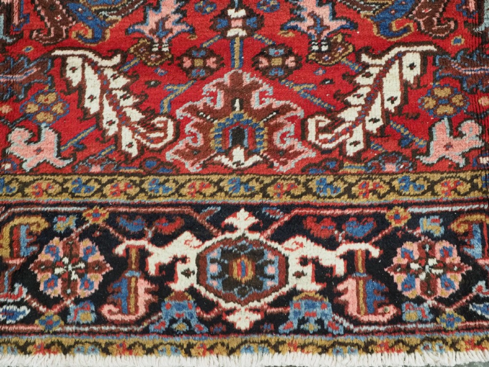 ANTIQUE HERIZ CARPET, ALL OVER DESIGN ON A BOLD RED GROUND, CIRCA 1920/30. View XI