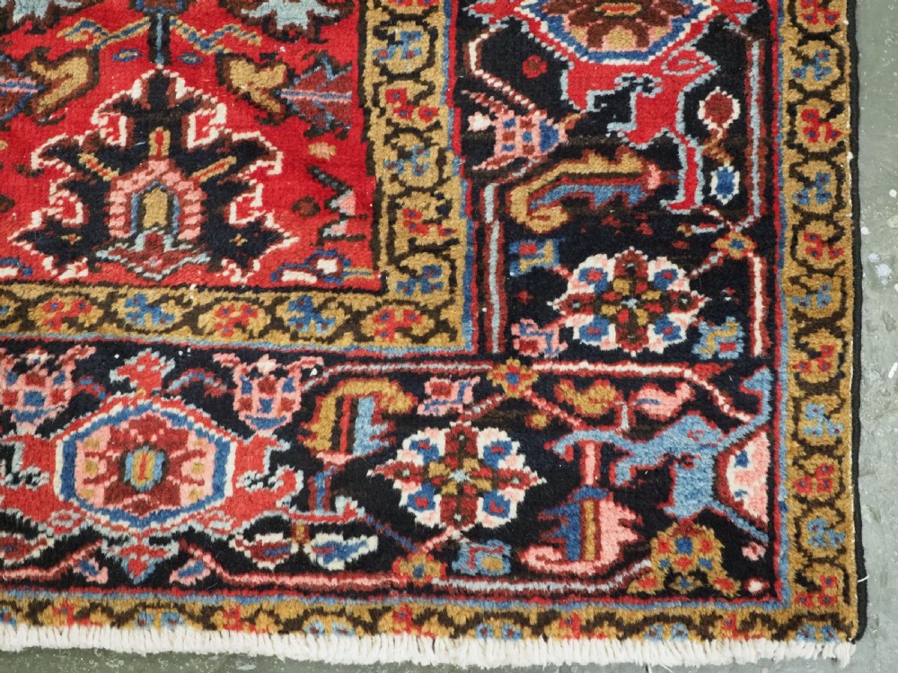 ANTIQUE HERIZ CARPET, ALL OVER DESIGN ON A BOLD RED GROUND, CIRCA 1920/30. View XII