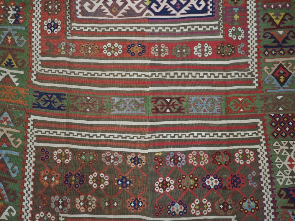 An antique Turkish Reyhanli flatweave kilim runner featuring multi-coloured geometric medallions joined along a central seam with a red border. View IX