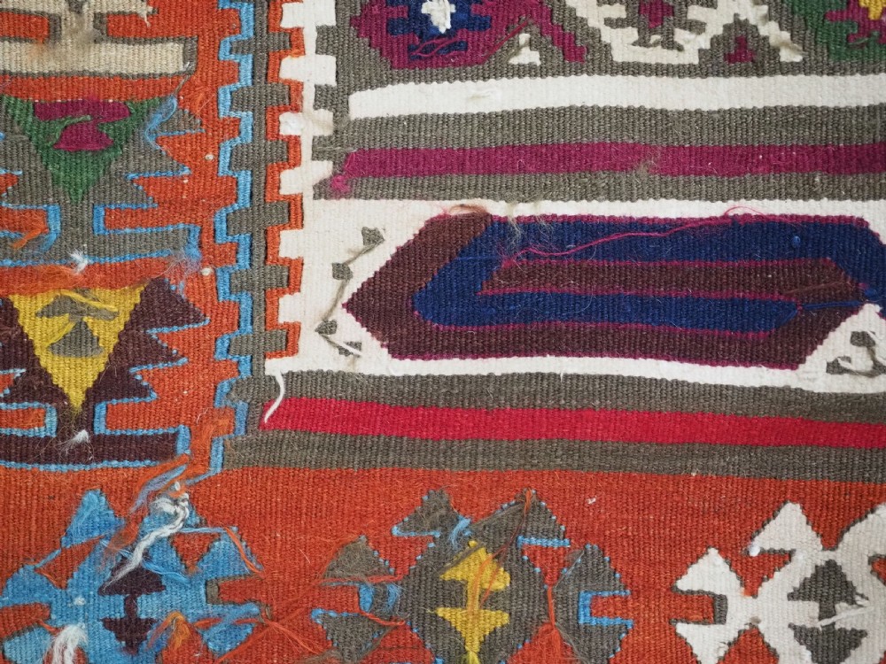 An antique Turkish Reyhanli flatweave kilim runner featuring multi-coloured geometric medallions joined along a central seam with a red border. View XIII