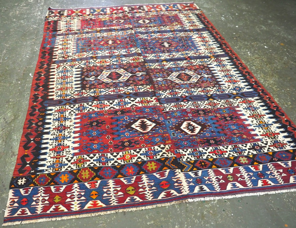 An antique Turkish Bergama Karakecili flatweave kilim rug featuring bold geometric diamond motifs woven in two connected vertical sections in shades of red, navy blue, and cream. View II