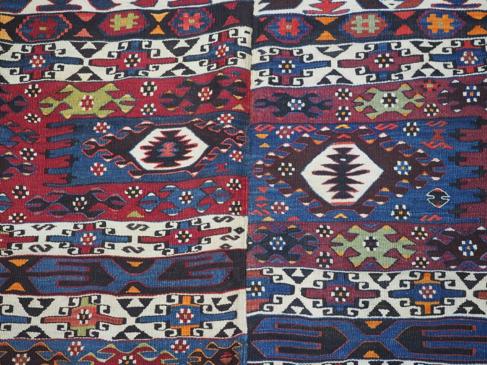 An antique Turkish Bergama Karakecili flatweave kilim rug featuring bold geometric diamond motifs woven in two connected vertical sections in shades of red, navy blue, and cream. View XI