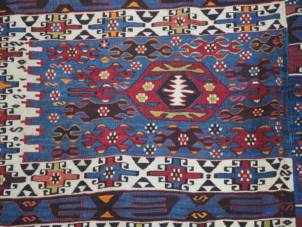 An antique Turkish Bergama Karakecili flatweave kilim rug featuring bold geometric diamond motifs woven in two connected vertical sections in shades of red, navy blue, and cream. View XII