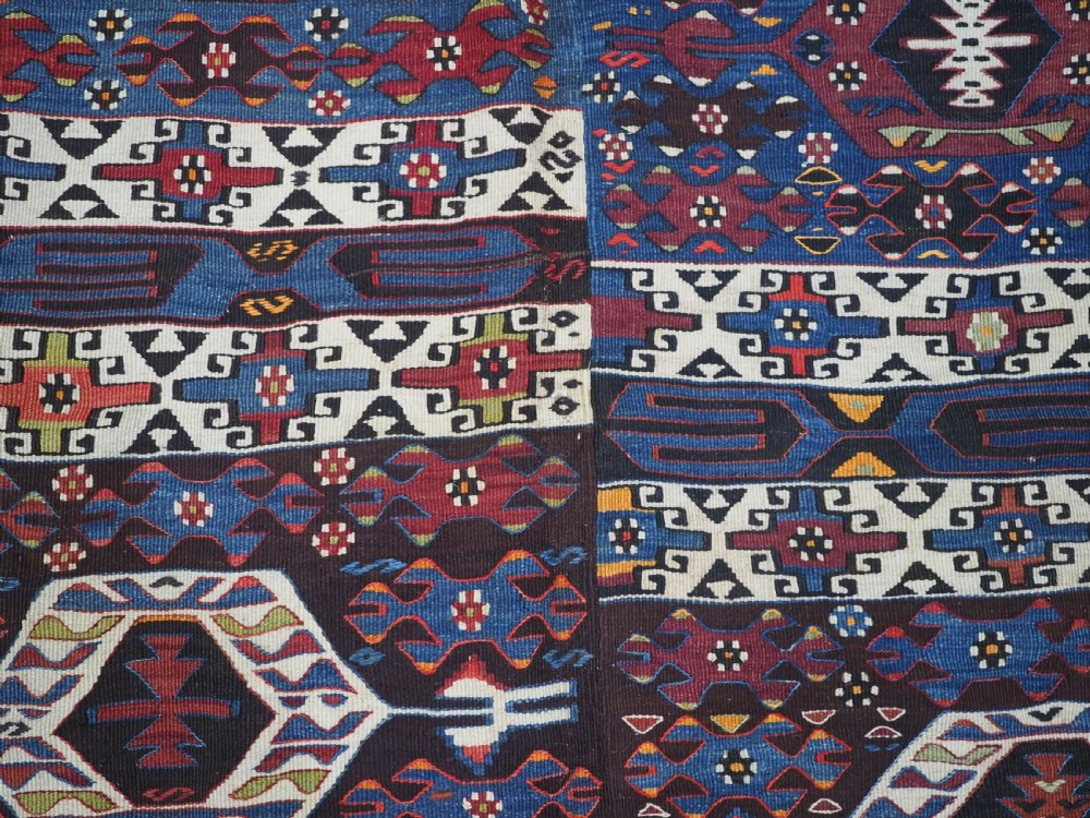 An antique Turkish Bergama Karakecili flatweave kilim rug featuring bold geometric diamond motifs woven in two connected vertical sections in shades of red, navy blue, and cream. View XIII