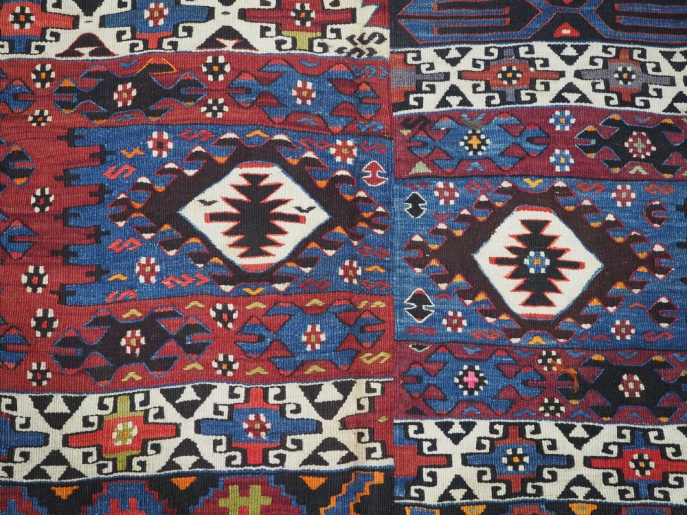 An antique Turkish Bergama Karakecili flatweave kilim rug featuring bold geometric diamond motifs woven in two connected vertical sections in shades of red, navy blue, and cream. View XIV