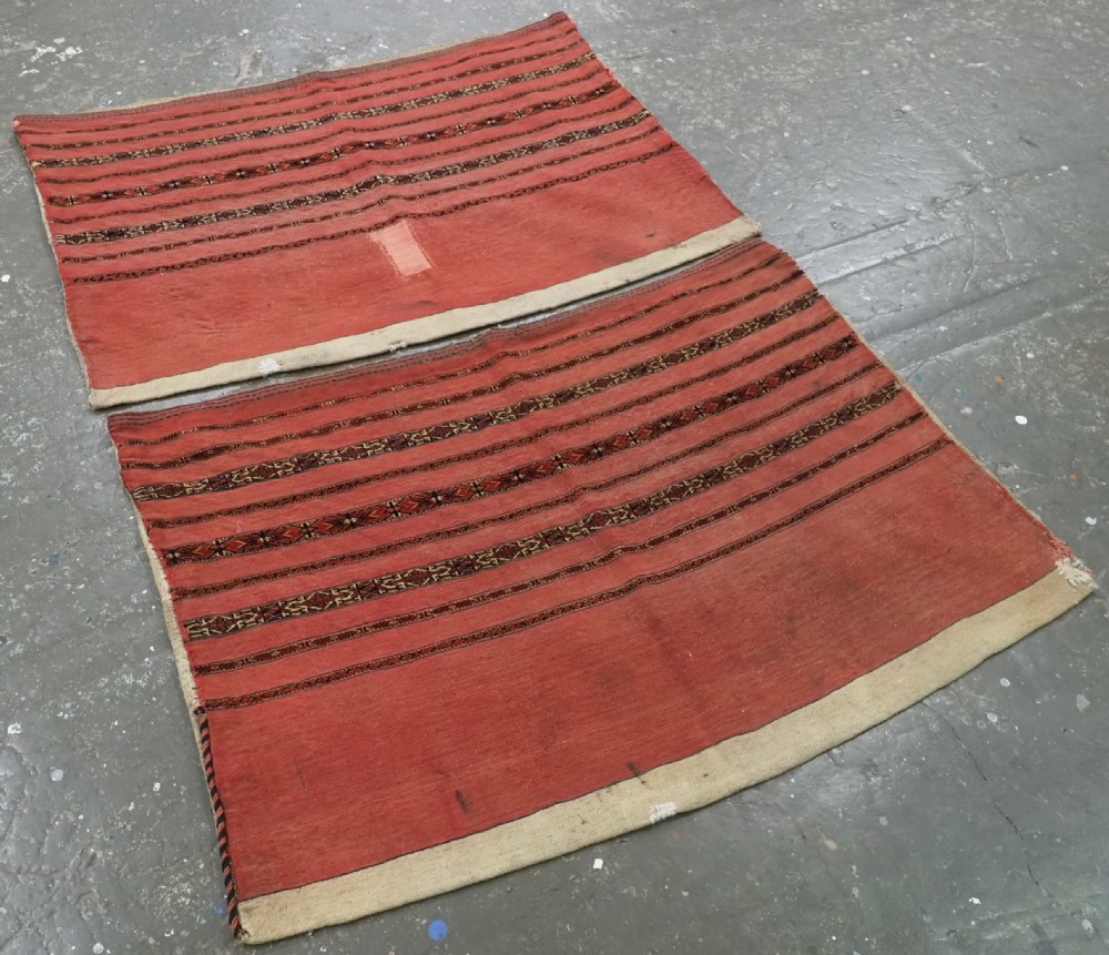 A pair of antique Tekke Turkmen woven wool Kizil cuval bags featuring horizontal red and patterned geometric stripes with cream selvedges. View II