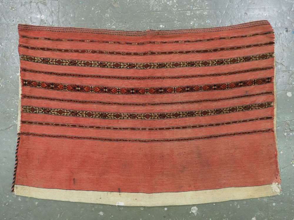 A pair of antique Tekke Turkmen woven wool Kizil cuval bags featuring horizontal red and patterned geometric stripes with cream selvedges. View III