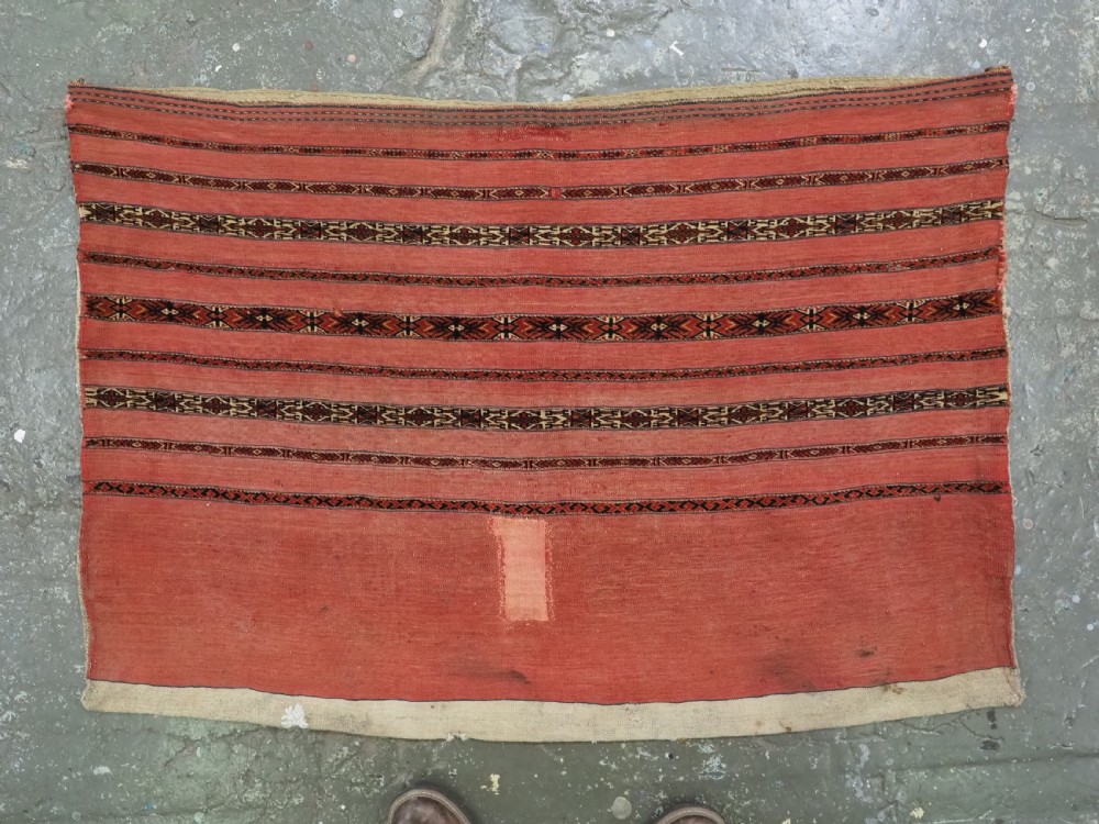 A pair of antique Tekke Turkmen woven wool Kizil cuval bags featuring horizontal red and patterned geometric stripes with cream selvedges. View IV