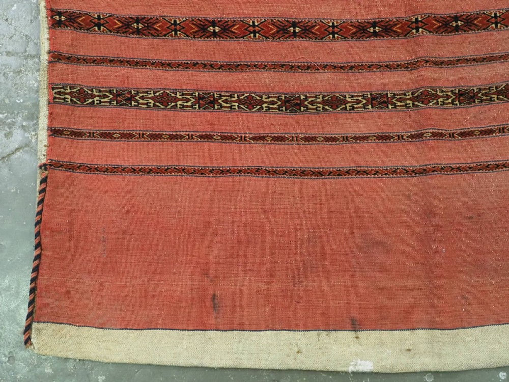 A pair of antique Tekke Turkmen woven wool Kizil cuval bags featuring horizontal red and patterned geometric stripes with cream selvedges. View VI