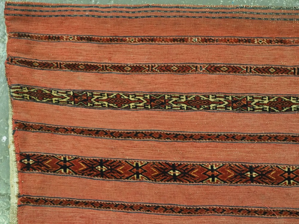 A pair of antique Tekke Turkmen woven wool Kizil cuval bags featuring horizontal red and patterned geometric stripes with cream selvedges. View VII