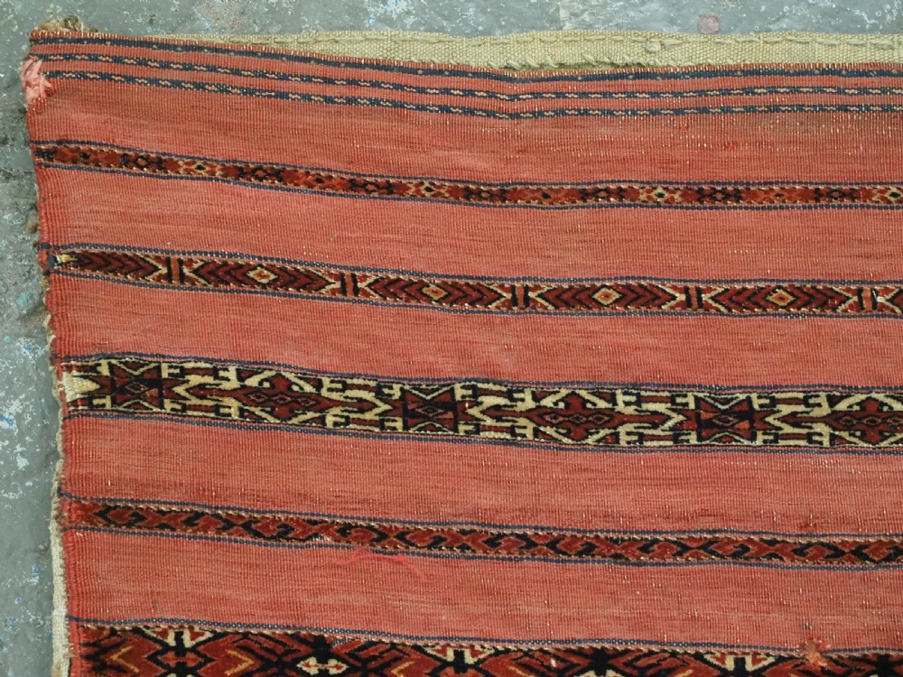 A pair of antique Tekke Turkmen woven wool Kizil cuval bags featuring horizontal red and patterned geometric stripes with cream selvedges. View VIII
