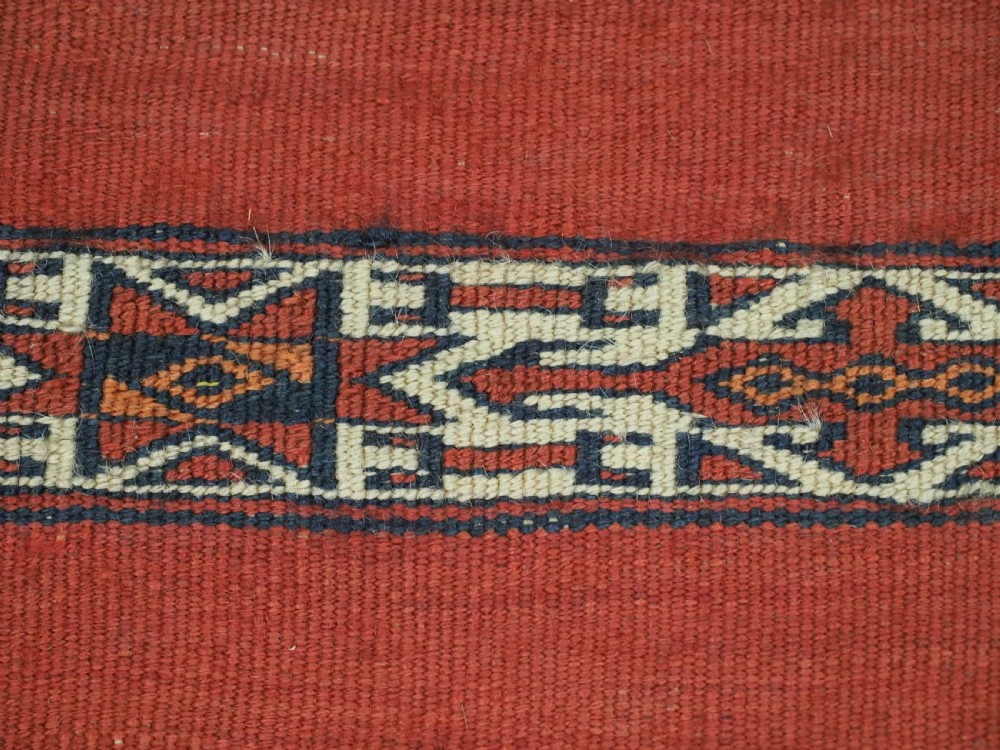 A pair of antique Tekke Turkmen woven wool Kizil cuval bags featuring horizontal red and patterned geometric stripes with cream selvedges. View XII