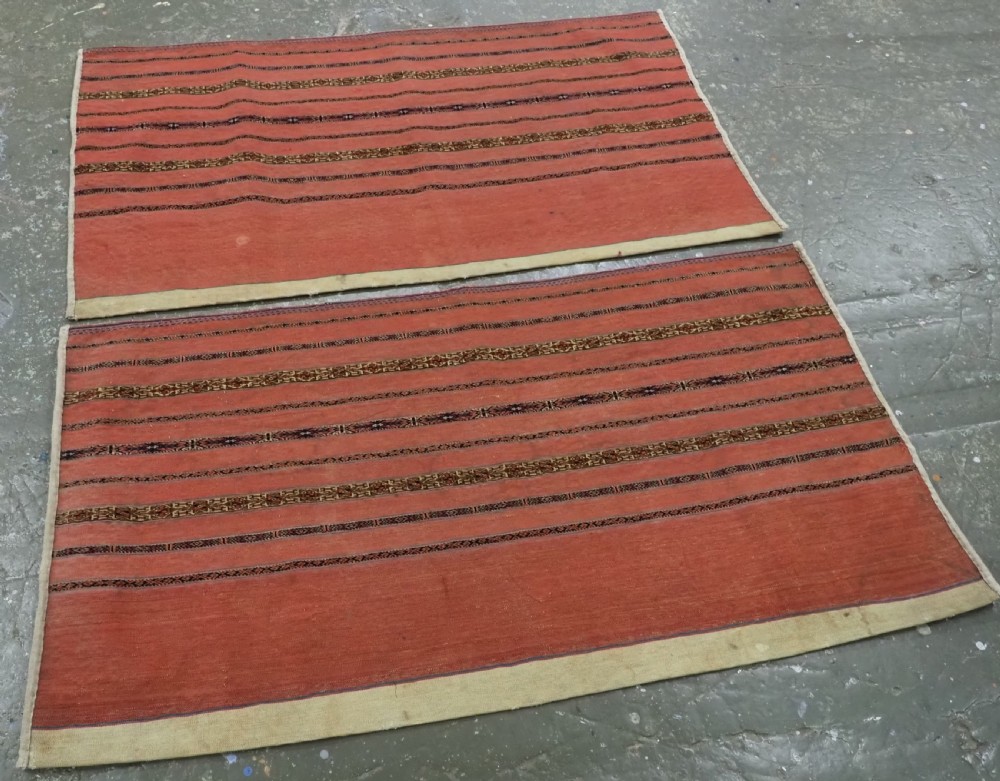 A pair of rectangular antique Turkmen Kizil chuval woven textiles in terracotta red with thin horizontal geometric bands and cream backing edges. View II