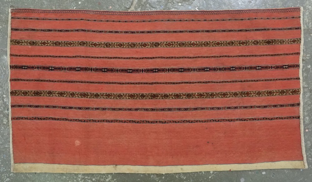 A pair of rectangular antique Turkmen Kizil chuval woven textiles in terracotta red with thin horizontal geometric bands and cream backing edges. View IV