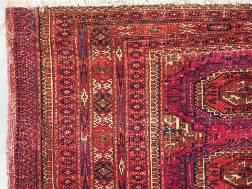 ANTIQUE TEKKE OR SARYK TURKMEN 9 GUL CHUVAL FACE, COCHINEAL DYE, CIRCA 1880. View IV