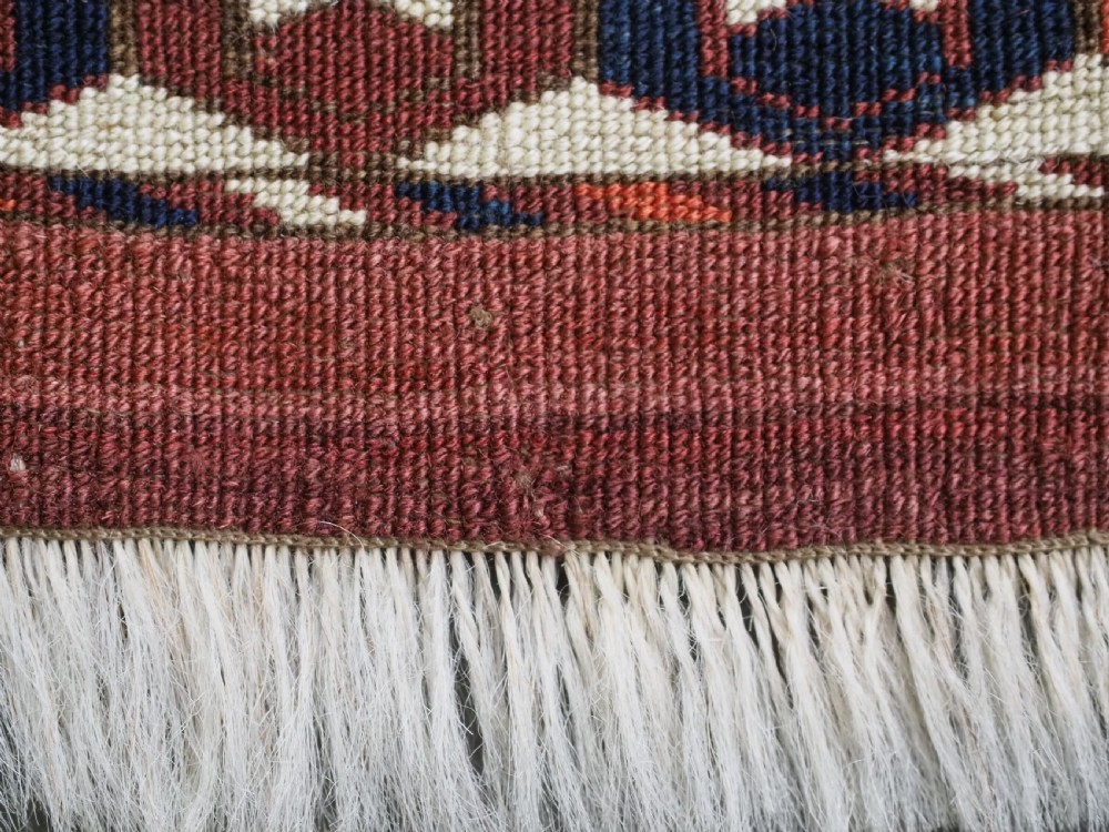 A horizontal handwoven Tekke Turkmen wool textile featuring three rectangular panels with tree designs bordered by intricate geometric patterns in red, navy, and ivory. View XIV