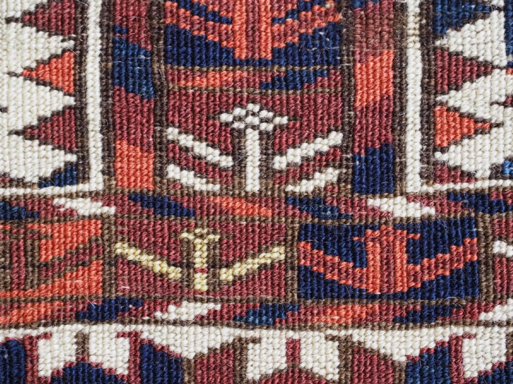 A horizontal handwoven Tekke Turkmen wool textile featuring three rectangular panels with tree designs bordered by intricate geometric patterns in red, navy, and ivory. View XV