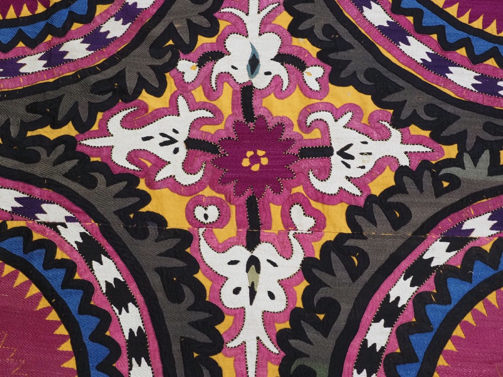 An antique Uzbek Samarkand suzani textile displaying nine large purple circular medallions framed by a yellow floral border. View IX