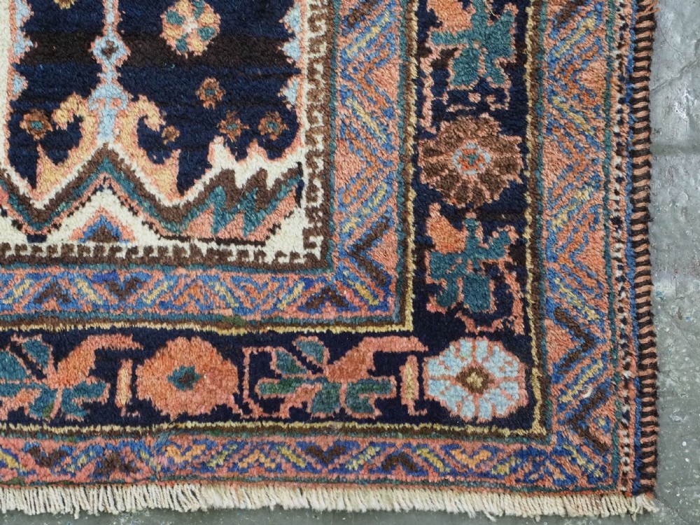 An antique hand-knotted Afshar wool rug featuring stylised dragon and phoenix motifs in blue, terracotta, and brown over an ivory ground within a geometric patterned border. View XIV