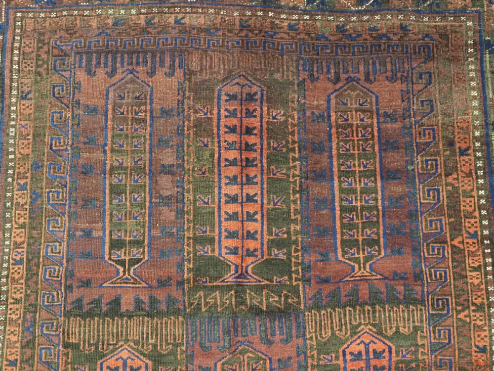 A late nineteenth-century hand-knotted wool Baluch carpet featuring repeated geometric column motifs in indigo, dark red, and purple shades within multiple patterned borders. View VIII