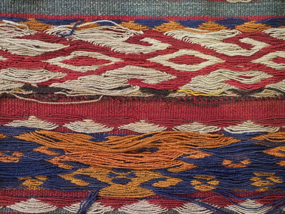 An antique Central Asian Uzbek Gajeri flatweave kilim rug featuring horizontal bands of geometric motifs woven in red, ochre, navy, and cream wool with fringed ends. View XII