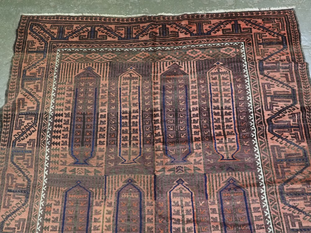 An antique hand-knotted wool carpet featuring a repeating kalam donneh pencil box pattern in shades of terracotta, dark brown, and indigo blue. View III
