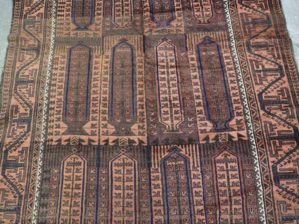 An antique hand-knotted wool carpet featuring a repeating kalam donneh pencil box pattern in shades of terracotta, dark brown, and indigo blue. View IV
